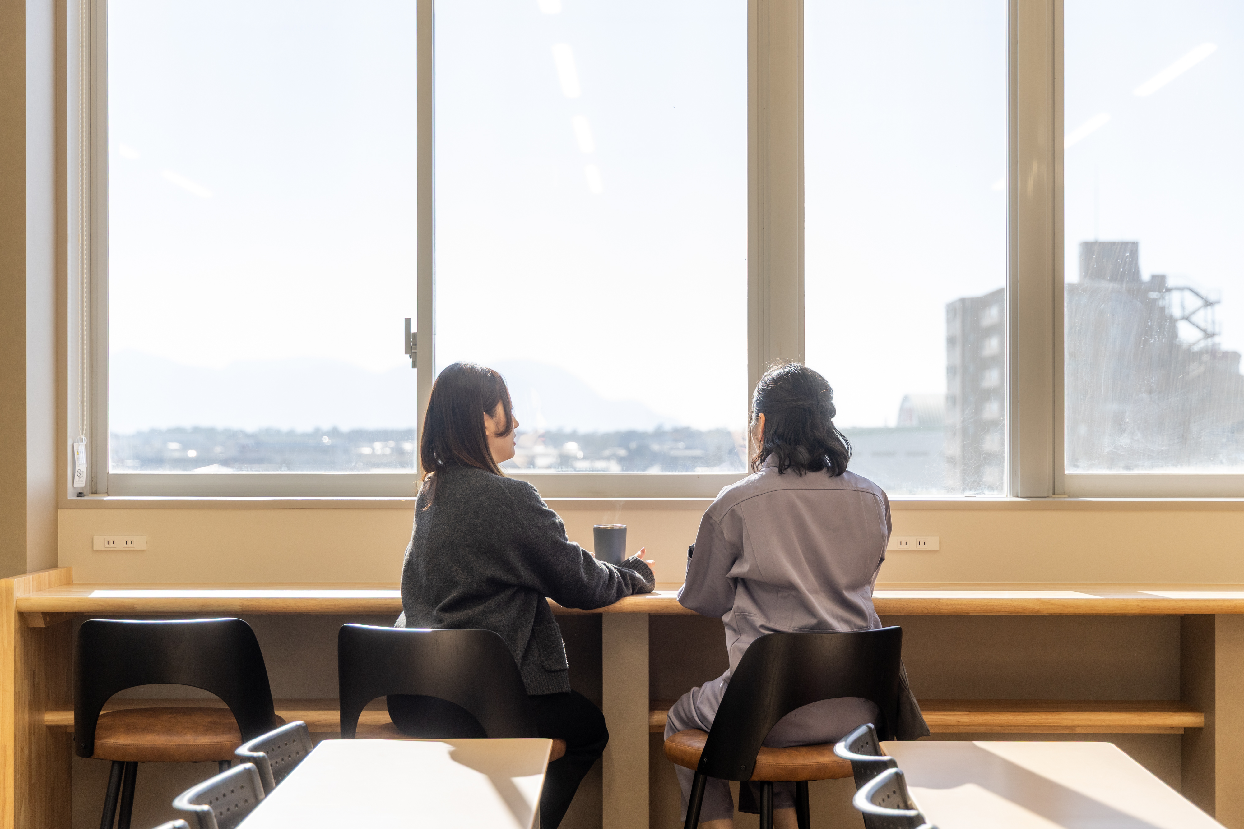 同僚と談笑しながら休憩する社員